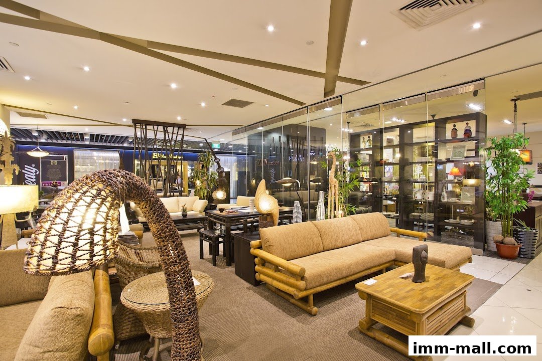 Interior view of a furniture store showcasing rattan and wooden living room sets.