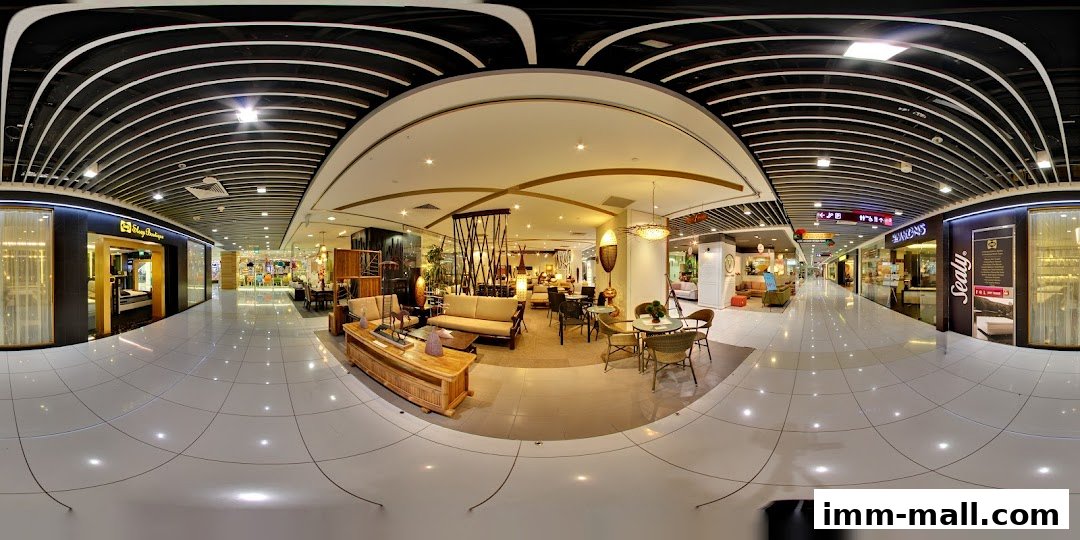 Interior view of a furniture store showcasing rattan and wooden furniture, including sofas, tables, and chairs.