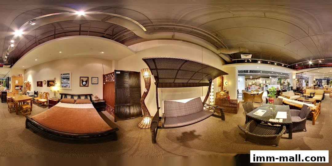 Interior view of a furniture store showcasing rattan and wooden furniture, including beds, swings, and dining sets.