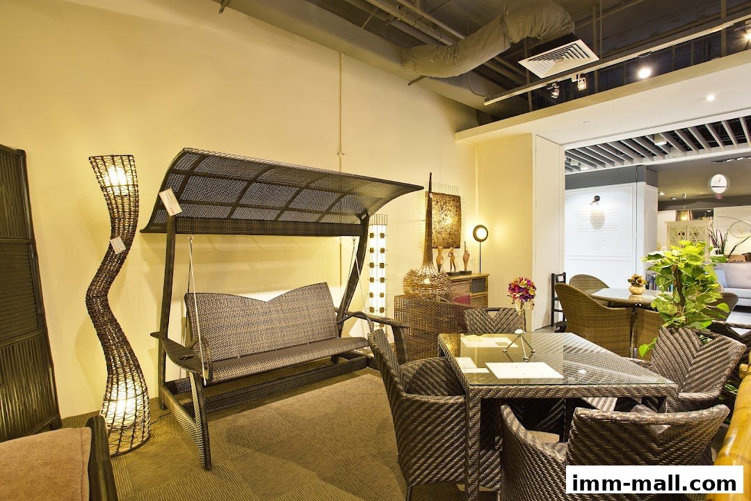 Interior shot of Rattan Pacific showcasing rattan furniture including a swing, dining set, and floor lamps.