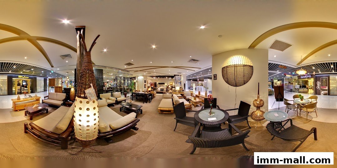 Interior view of Rattan Pacific furniture store showcasing various rattan and wooden furniture sets.