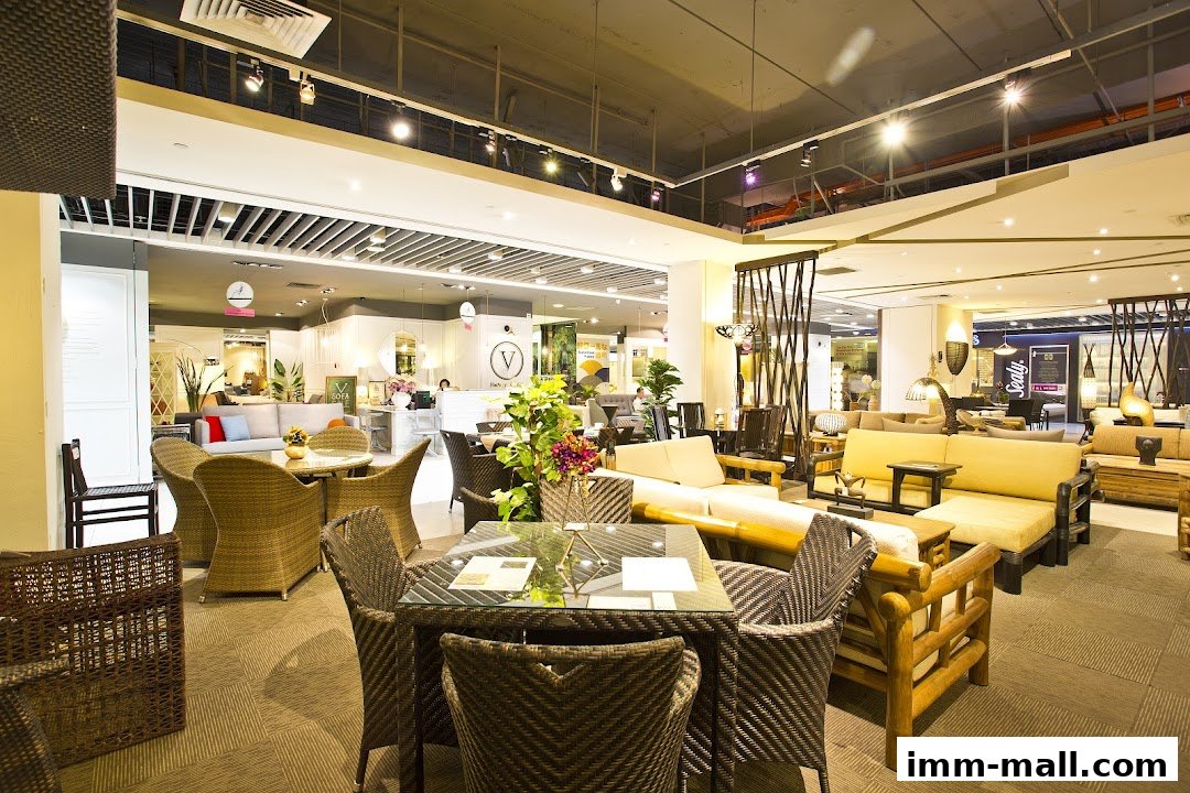 Interior view of a furniture store showcasing various rattan and wooden seating arrangements.