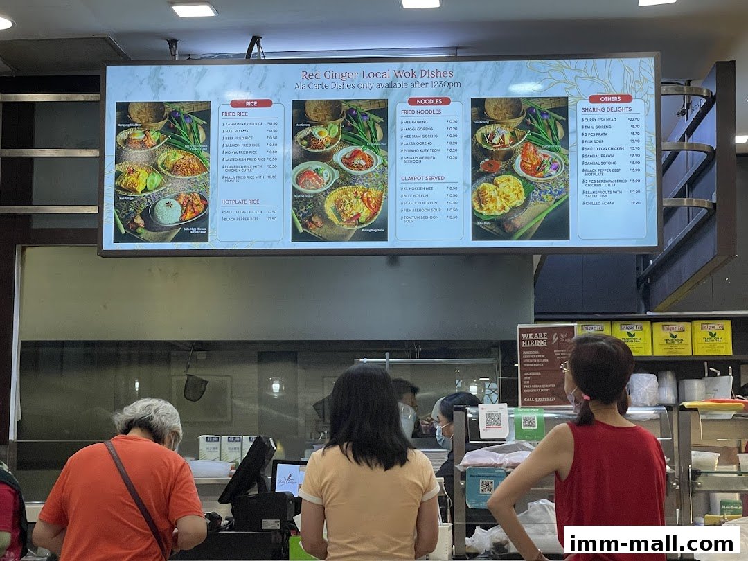 A digital menu board displaying various local wok dishes with prices and images.