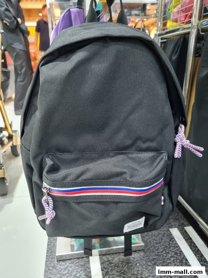 A black Samsonite backpack with red, white, and blue stripes on the front pocket.