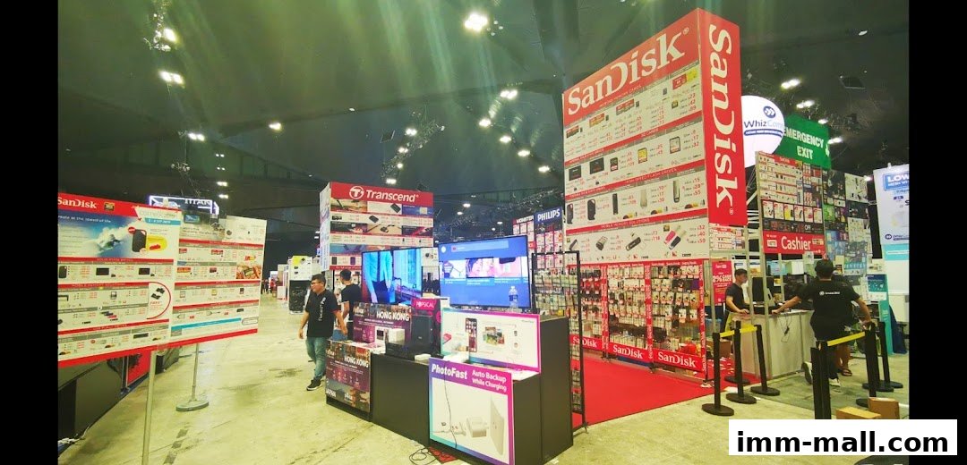 A retail booth showcasing SanDisk and Transcend storage products with pricing information.