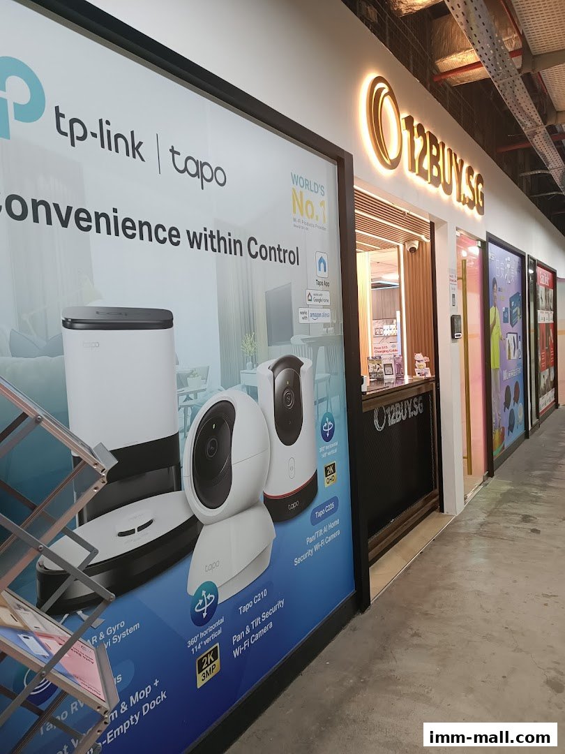 The exterior of the 12BUY.SG shop, featuring a large advertisement for TP-Link Tapo smart home devices.