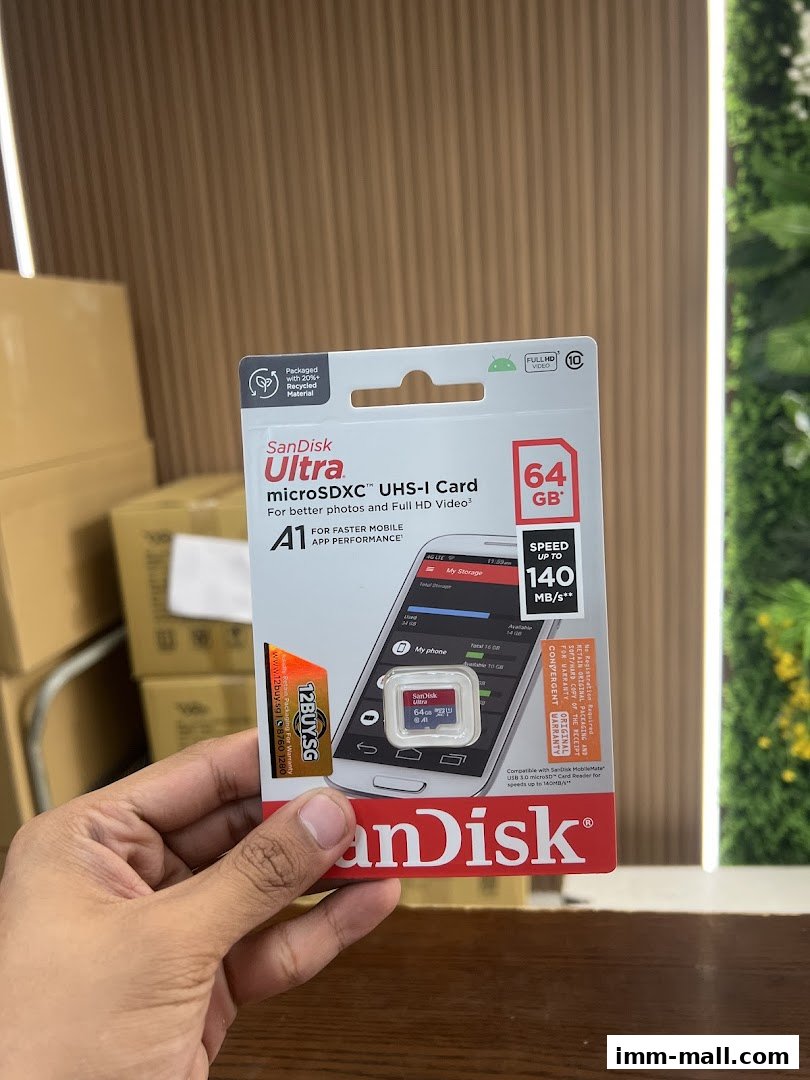 A hand holds a SanDisk Ultra 64GB microSDXC UHS-I card package.