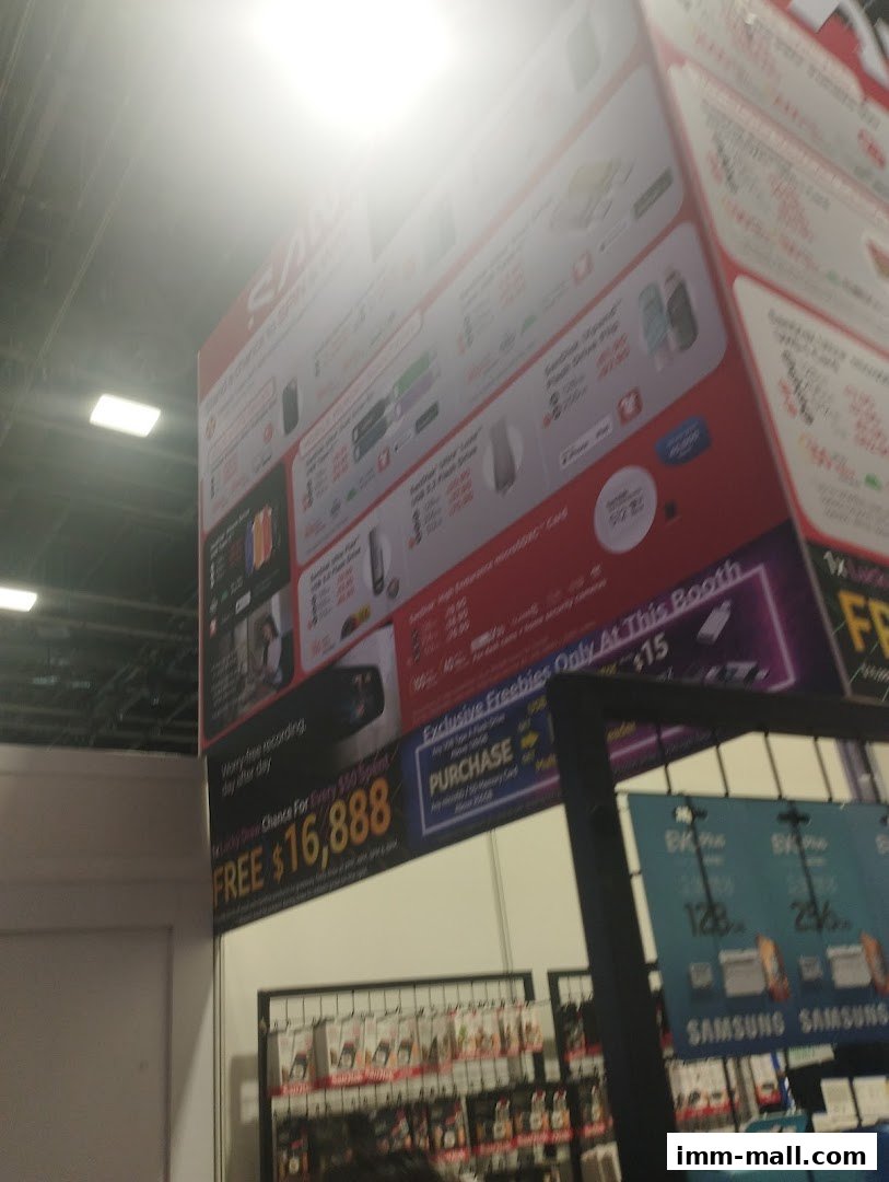 A large display board with various SanDisk products and promotions, including a giveaway.