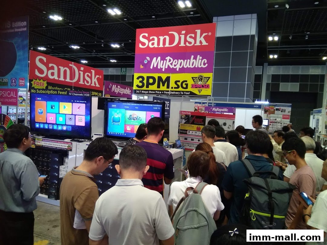 A crowd of people gathered around SanDisk and MyRepublic displays at a promotional event.