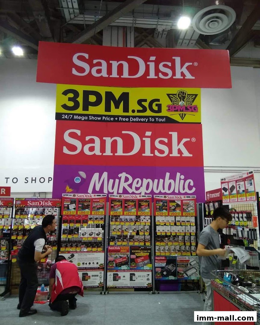 A retail display featuring SanDisk products with pricing and promotional banners.