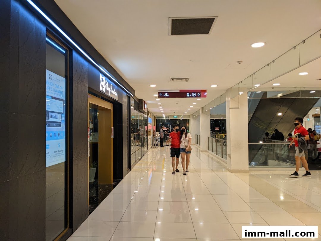 The entrance to the Sealy Sleep Boutique shop with a display window and people walking by.