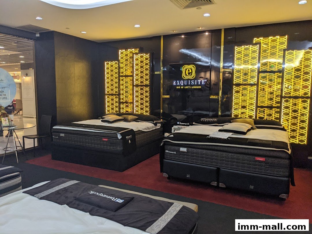 Luxurious beds displayed in a modern sleep boutique with elegant gold accents.