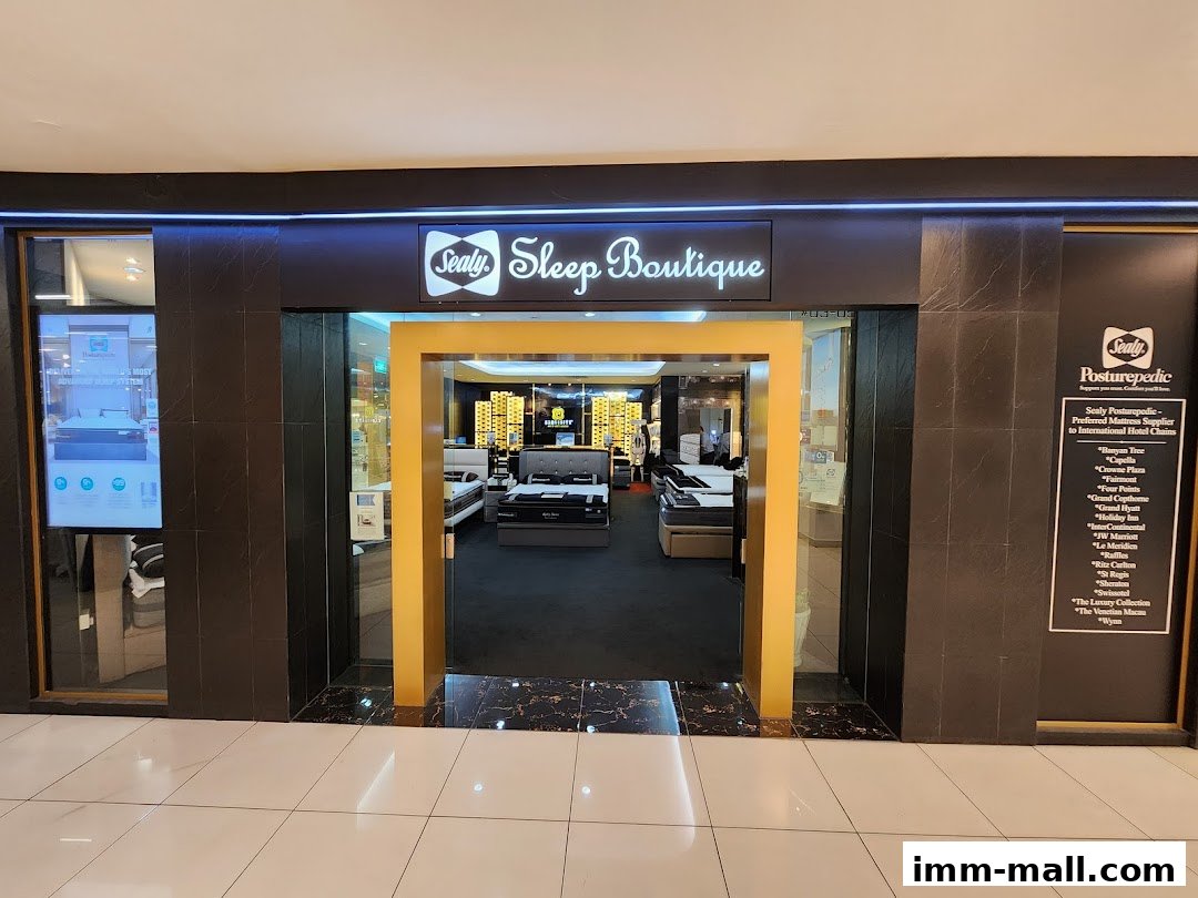 The entrance to the Sealy Sleep Boutique, showcasing various mattresses and a list of hotel clients.