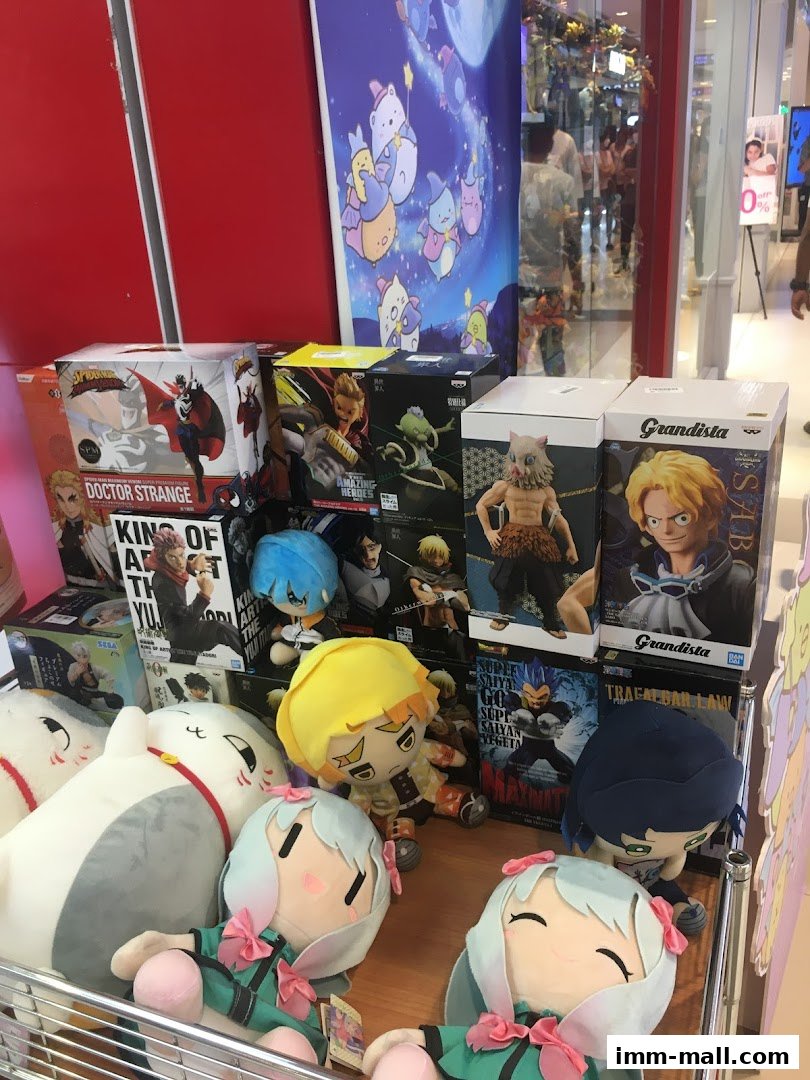 A display of anime figurines and plush toys, including characters from Doctor Strange and Dragon Ball.