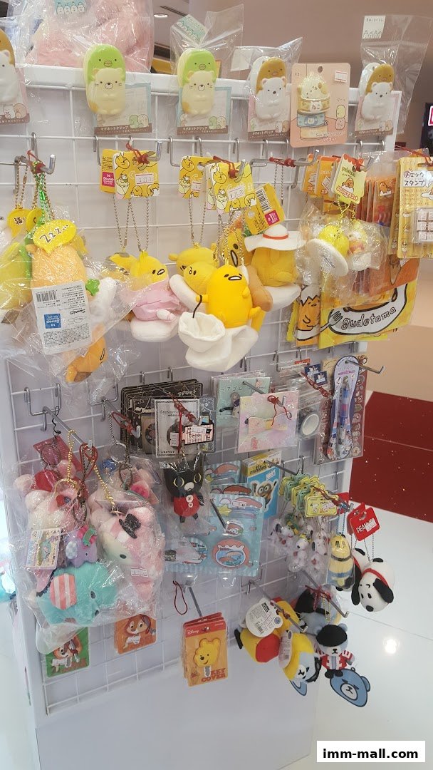 A display wall filled with cute plush toys, keychains, and stationery featuring popular characters.