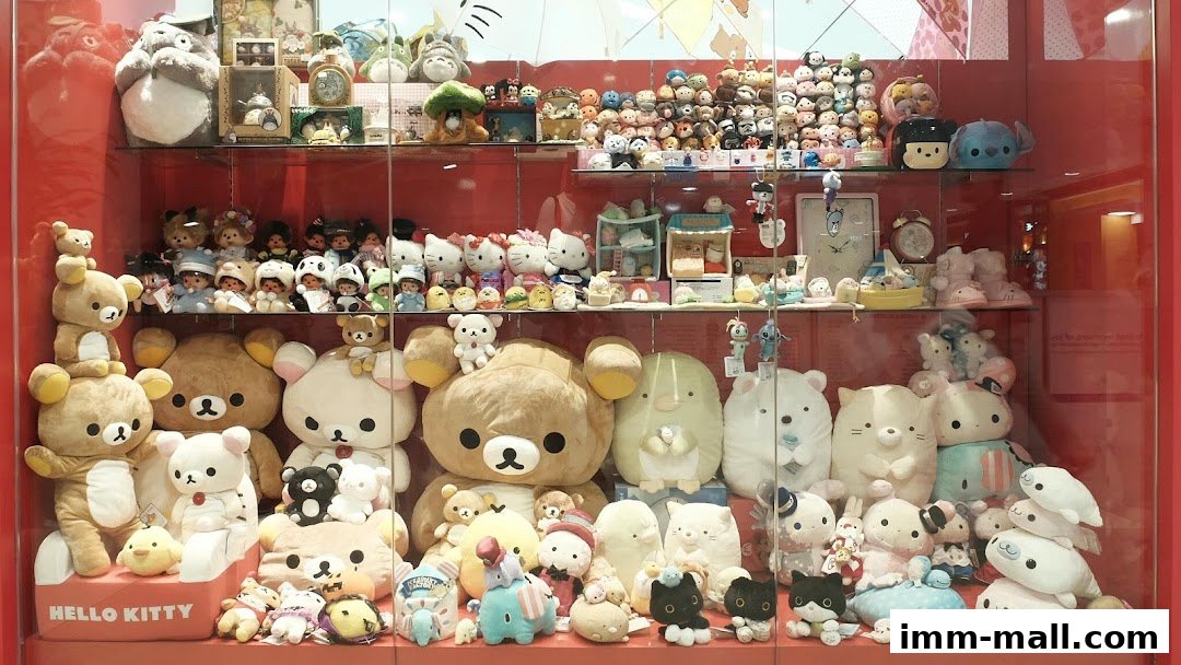 A display case filled with a variety of cute plush toys, including Rilakkuma and Hello Kitty.