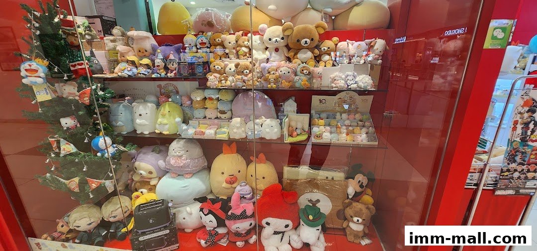 A display window filled with various plush toys, including characters like Doraemon, Hello Kitty, and Rilakkuma, with a Christmas tree.