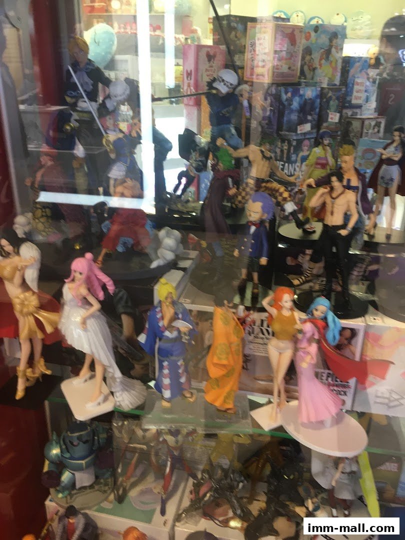 A display case filled with various anime character figurines and merchandise.