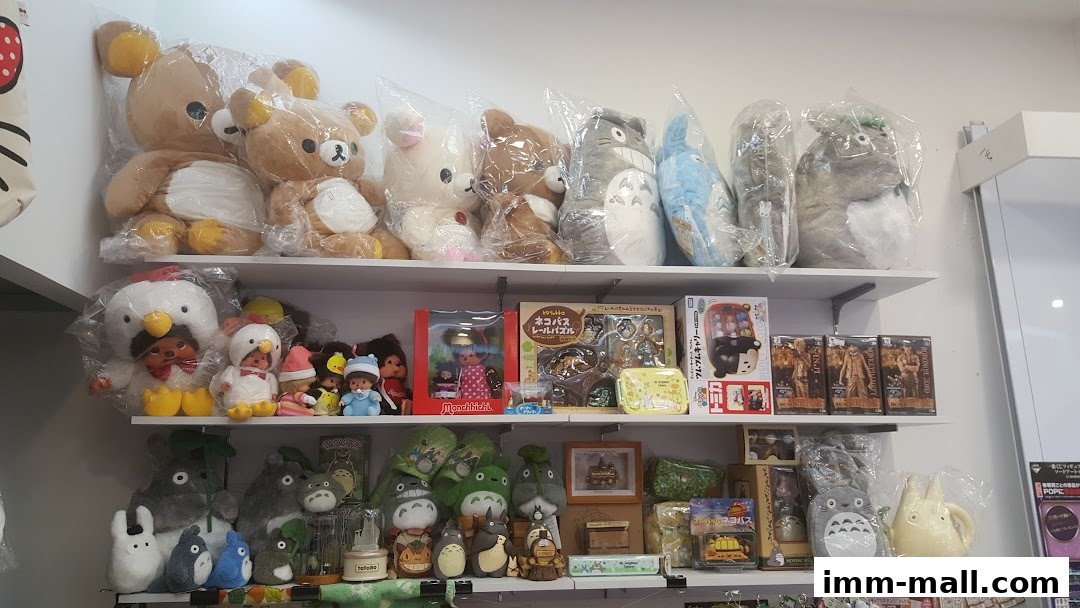 Shelves filled with various plush toys, dolls, and anime merchandise, including Totoro and Rilakkuma.