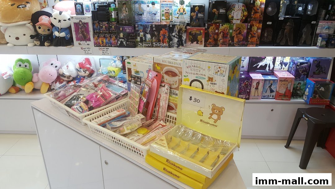A retail shop display filled with anime figures, plush toys, and Rilakkuma merchandise.