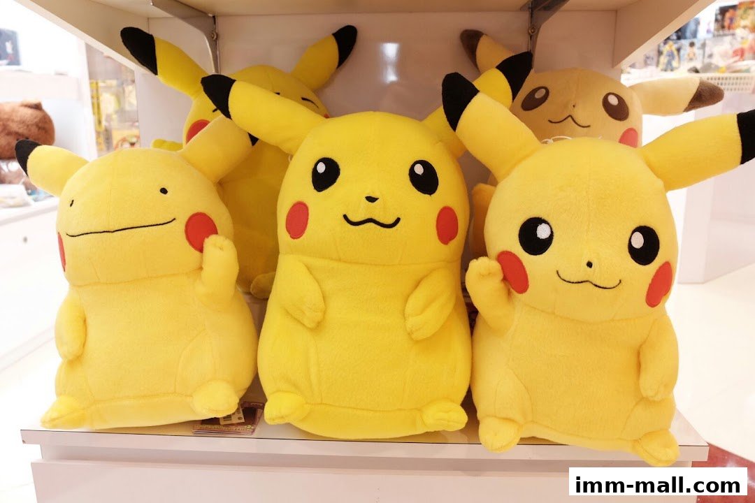 A display of various plush toys, primarily Pikachu and Ditto characters, on a shelf.