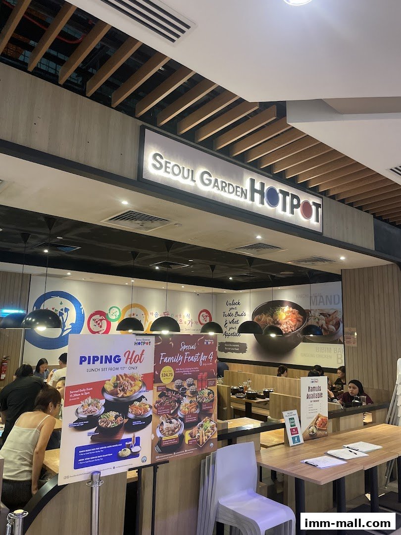 Interior of Seoul Garden Hotpot with promotional posters and diners.