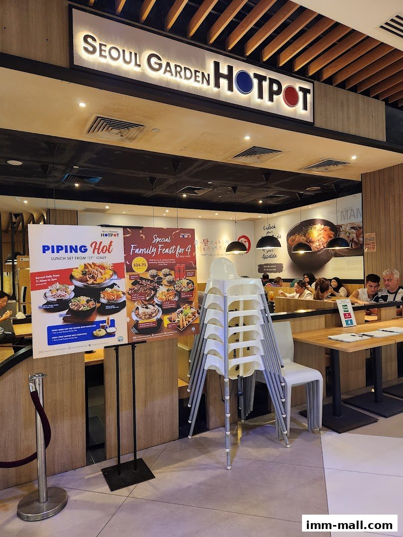 The entrance of Seoul Garden Hotpot cafe with a promotional poster and stacked chairs.