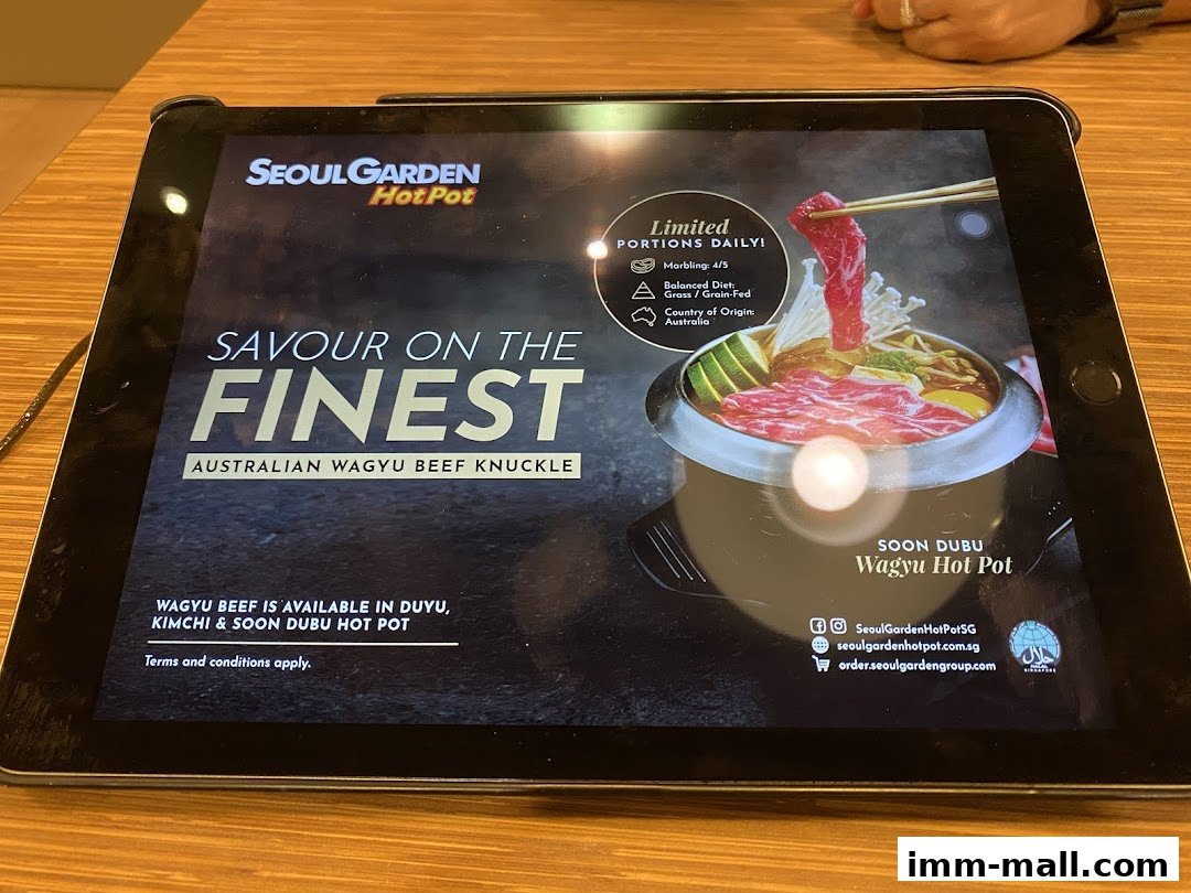 A tablet displays a promotion for Seoul Garden Hot Pot's Australian Wagyu Beef Knuckle.