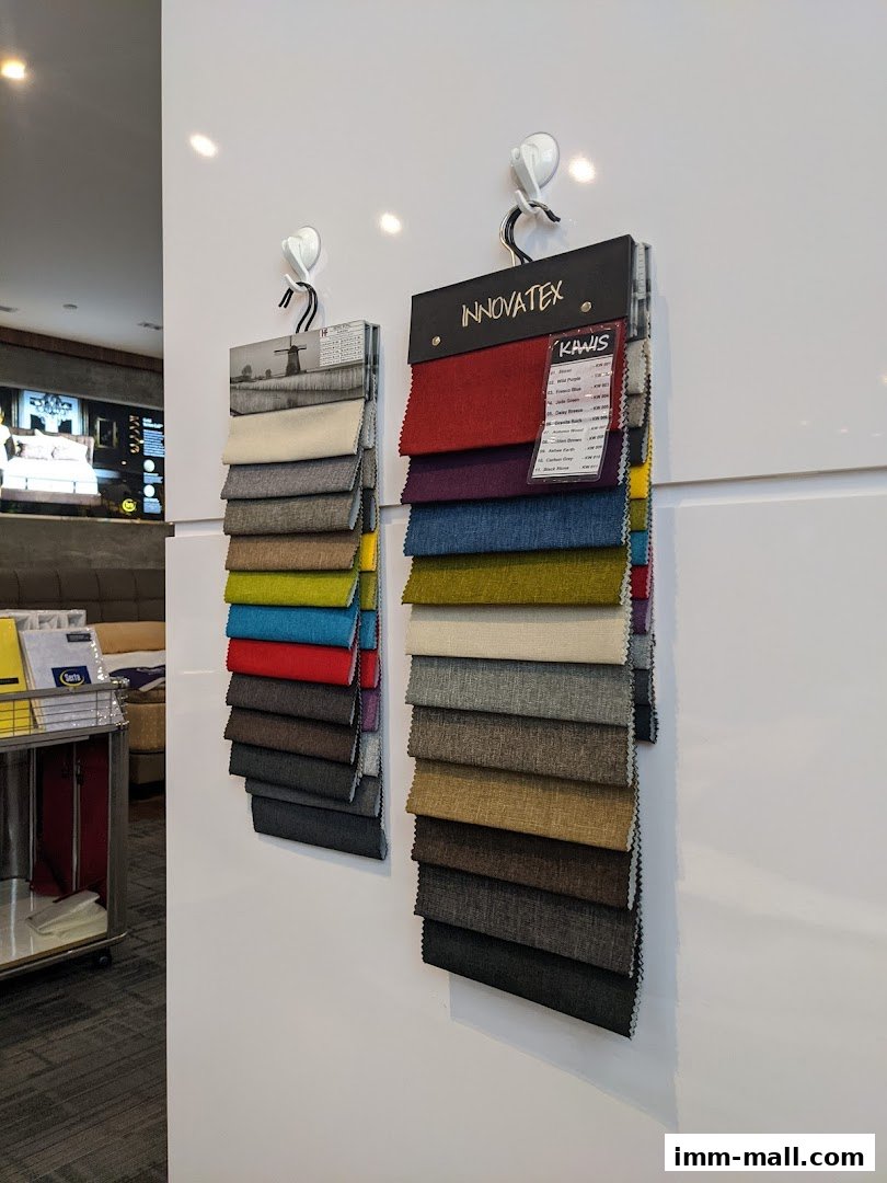 Fabric swatches displayed on a white wall, showcasing various colors and textures.
