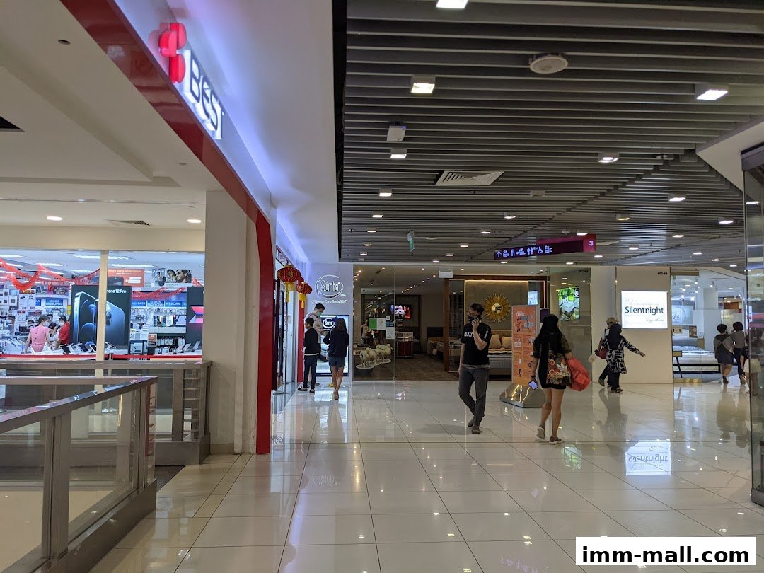Interior view of a shopping mall with various stores, including a Serta Sleep Center.