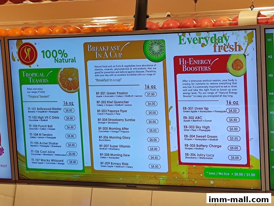 A digital menu board displaying various fruit juices and smoothies with prices.