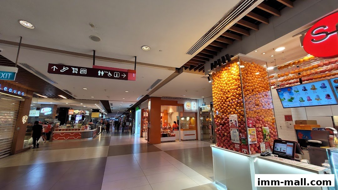 A brightly lit juice shop with a large display of fresh fruits and a menu board.