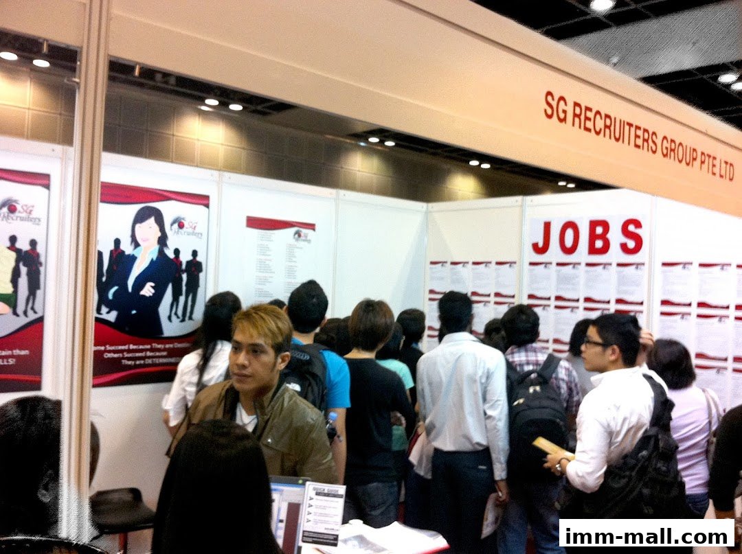 People gathered at a job fair booth for SG Recruiters Group Pte Ltd.