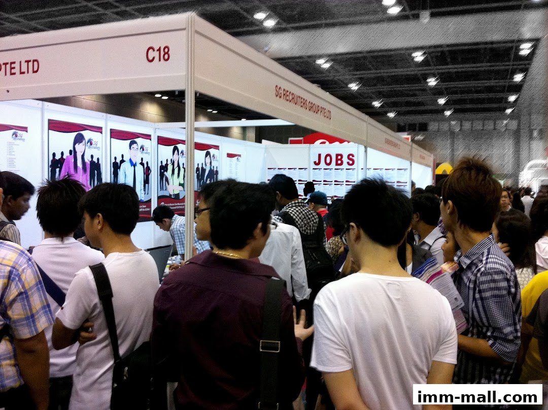 People gathered at a job fair booth for SG Recruiters Group Pte Ltd.