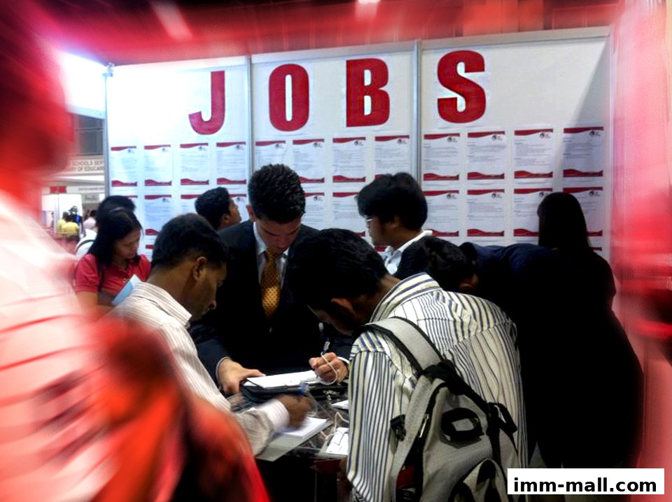 People gathered around a display with the word "JOBS" prominently displayed.