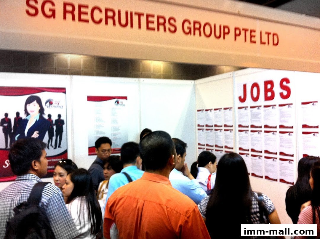 People gathered at a recruitment fair booth for SG Recruiters Group Pte Ltd, with job listings displayed.