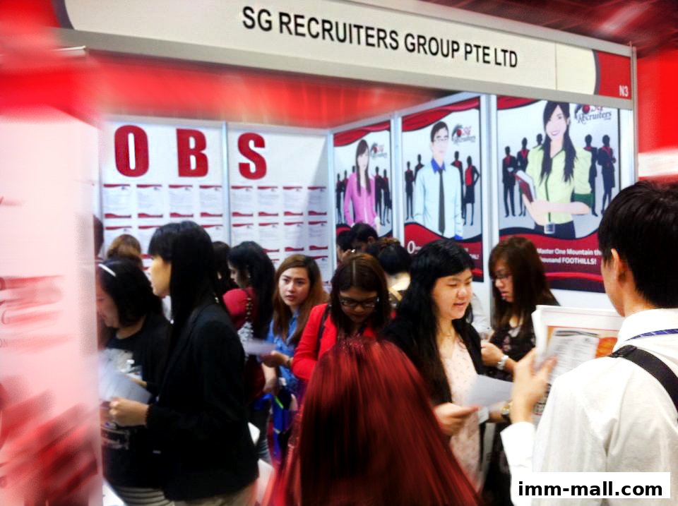 People gathered at a recruitment event booth for SG Recruiters Group Pte Ltd.