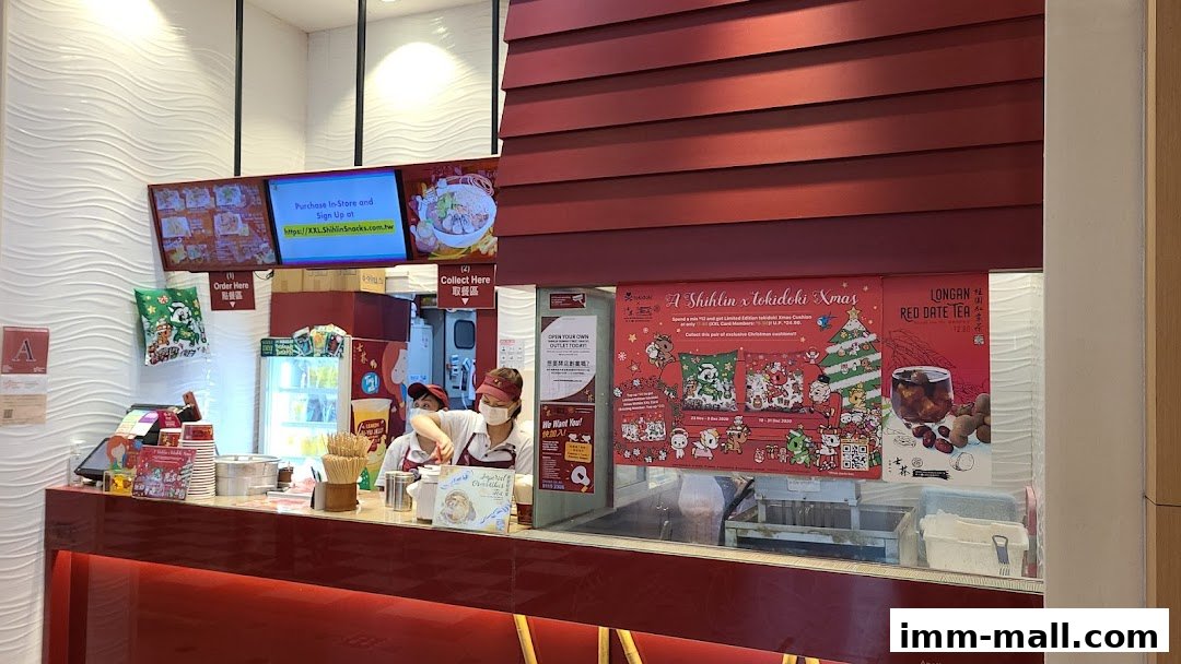 The counter of Shihlin Taiwan Street Snacks with staff preparing food and promotional posters.
