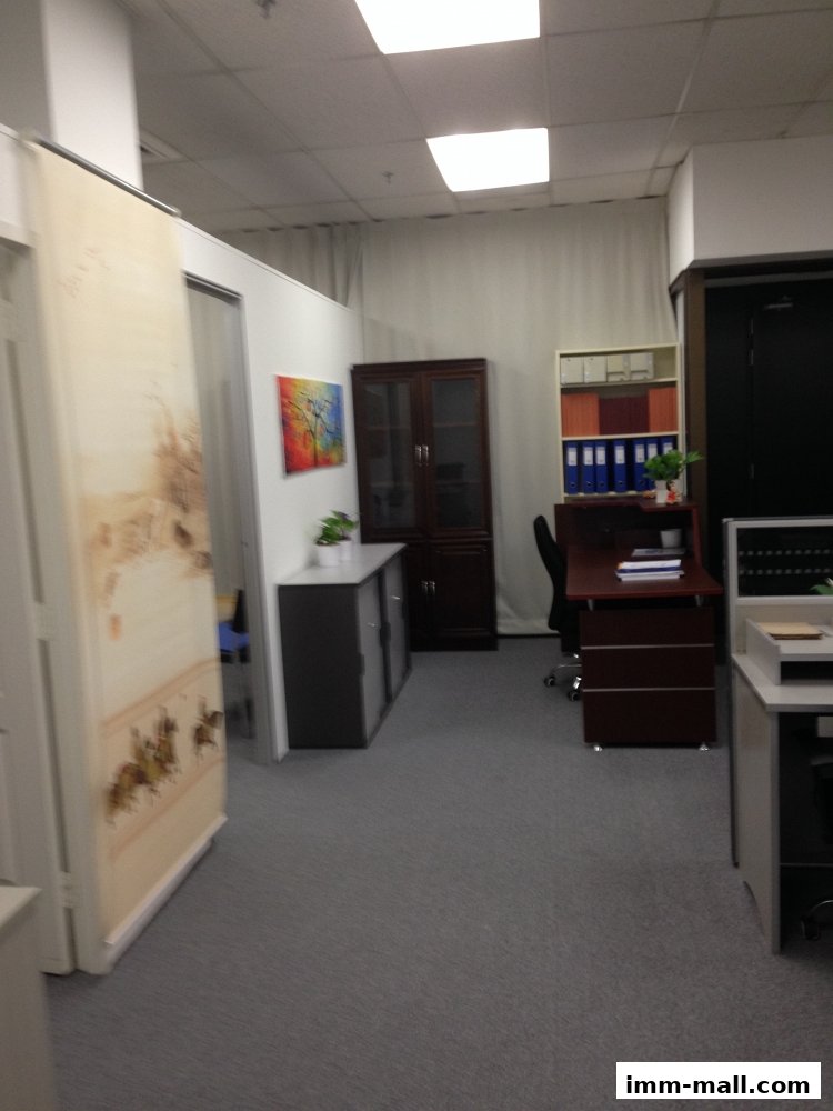 An office interior with desks, cabinets, and artwork, suggesting a professional workspace.