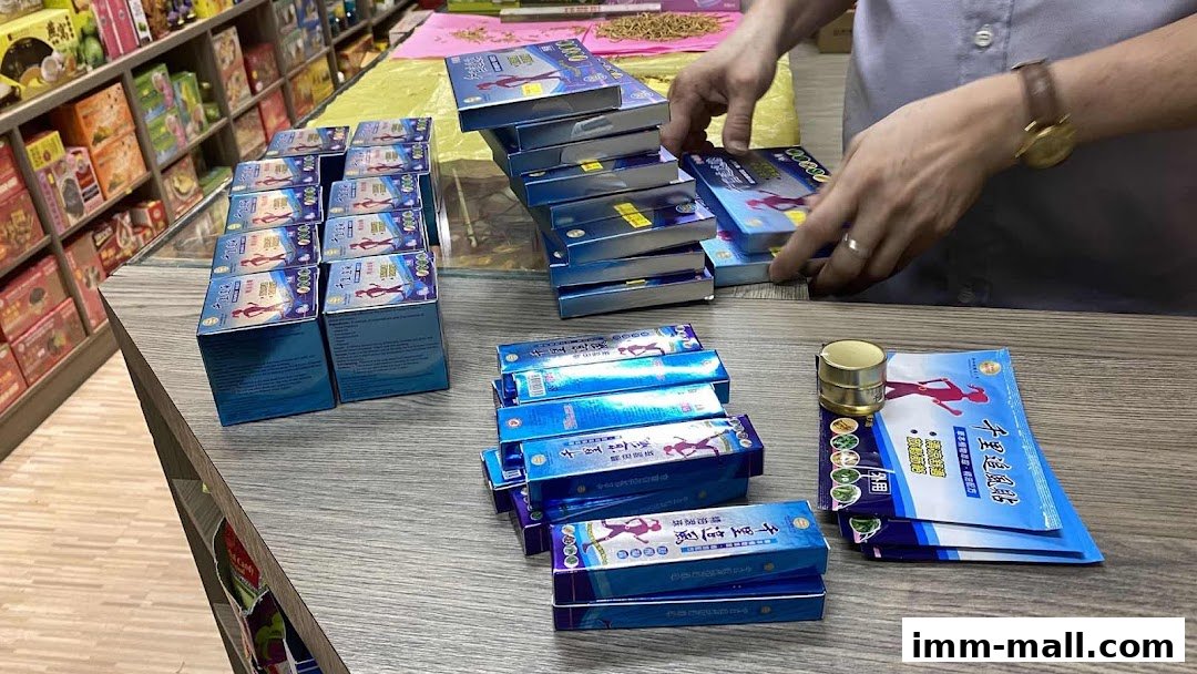 A person is arranging boxes of health products on a counter in a shop.