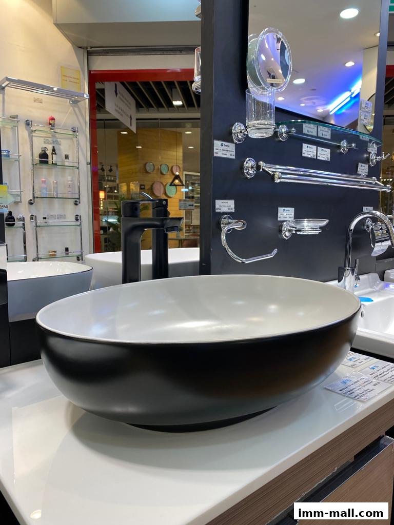 A modern black and white basin with a sleek faucet and bathroom accessories displayed.