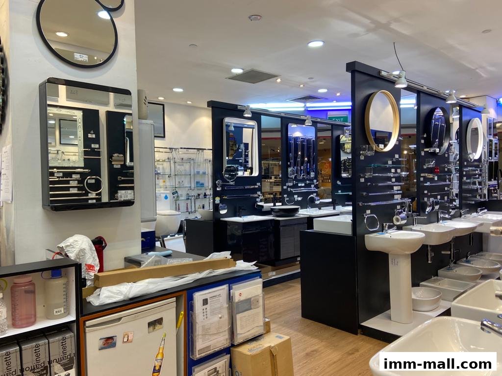 Interior view of a bathroom fixtures showroom displaying sinks, mirrors, and faucets.