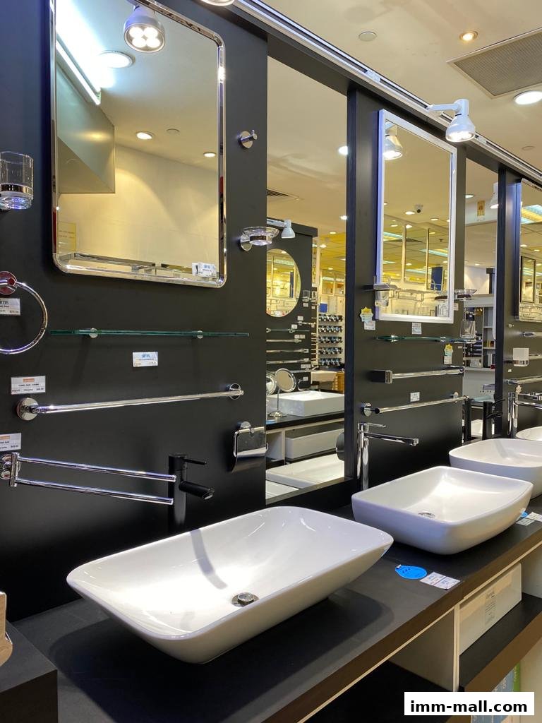 A display of modern bathroom sinks and accessories, including mirrors and faucets.