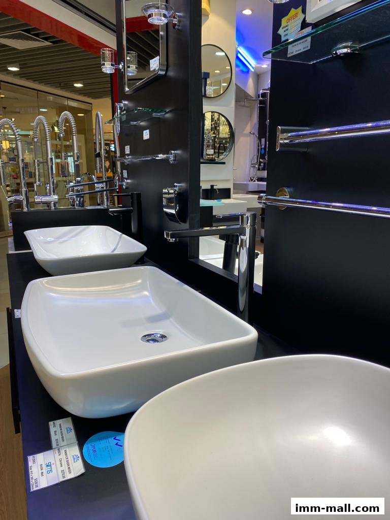 Modern bathroom sinks and fixtures displayed in a retail store setting.