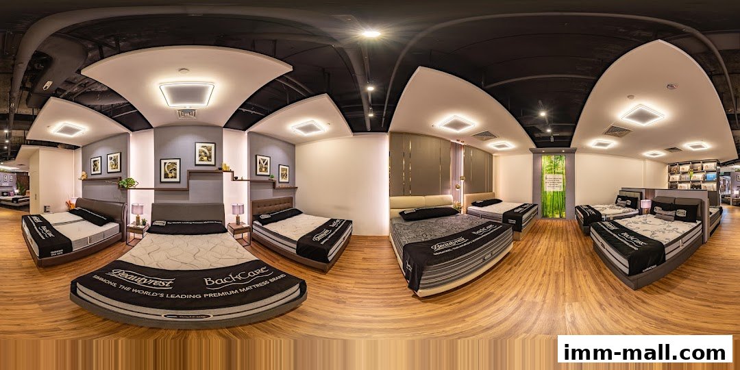 Interior view of a Simmons Gallery mattress store showcasing multiple beds and bedding.