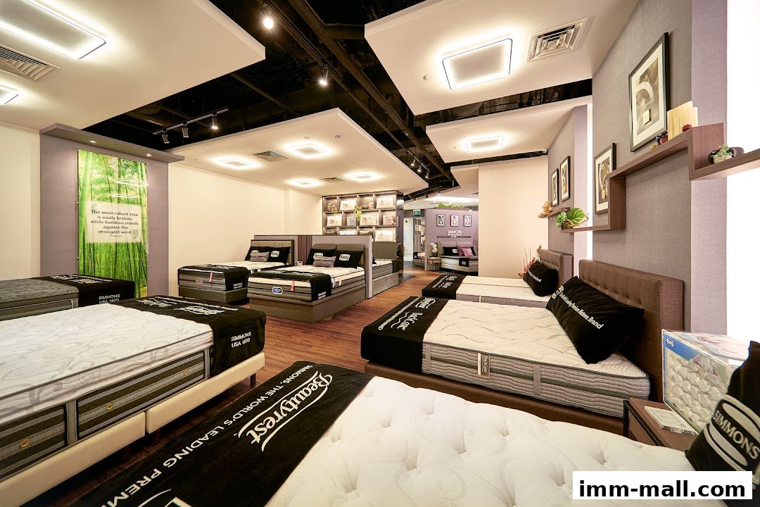 Interior of a Simmons Gallery mattress store showcasing multiple beds and mattresses.