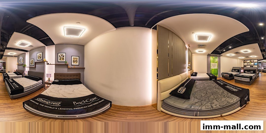 Interior view of a Simmons Gallery mattress store showcasing various beds and mattresses.