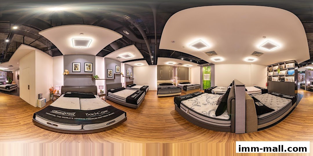 Interior view of a Simmons Gallery mattress store showcasing various beds and bedding products.
