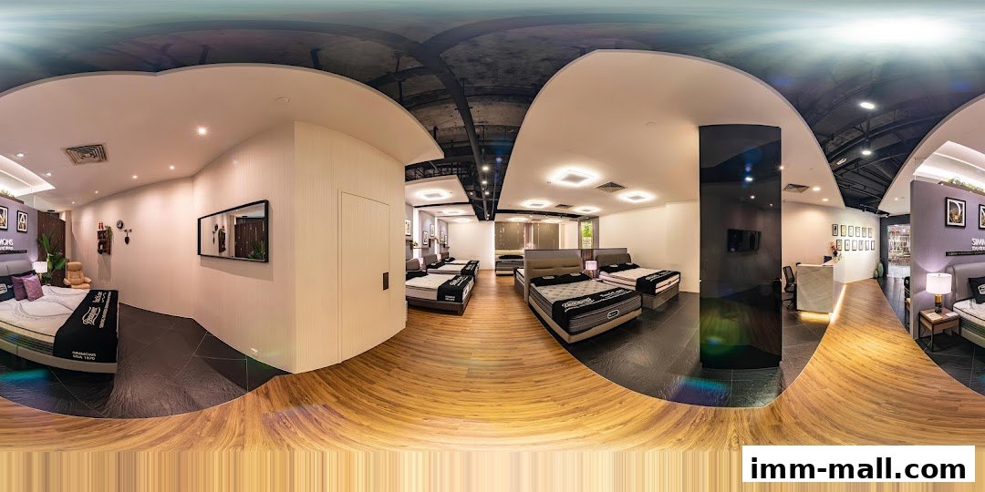 Interior view of a Simmons Gallery mattress store showcasing multiple beds and a reception area.