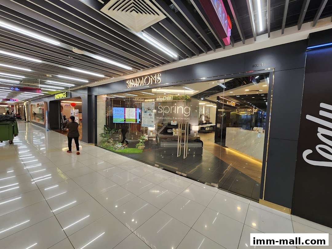 The Simmons Gallery shop front with a modern glass facade displaying mattresses and a reception desk.